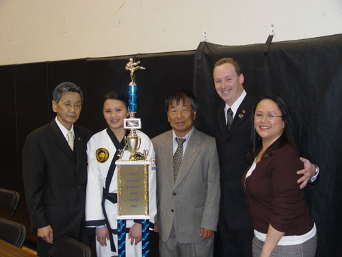 L to R: Grand Master C. I. Kim, Shaina Kennedy (Grand Champion of Tournament), Grand Master M. K. Kim, Master Patrick Kennedy, and Master Marie Kennedy